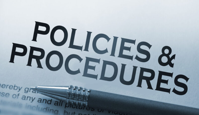 Policies and procedures memo on notebook with pen. Business concept Policies and procedures memo on notebook with pen. Business concept